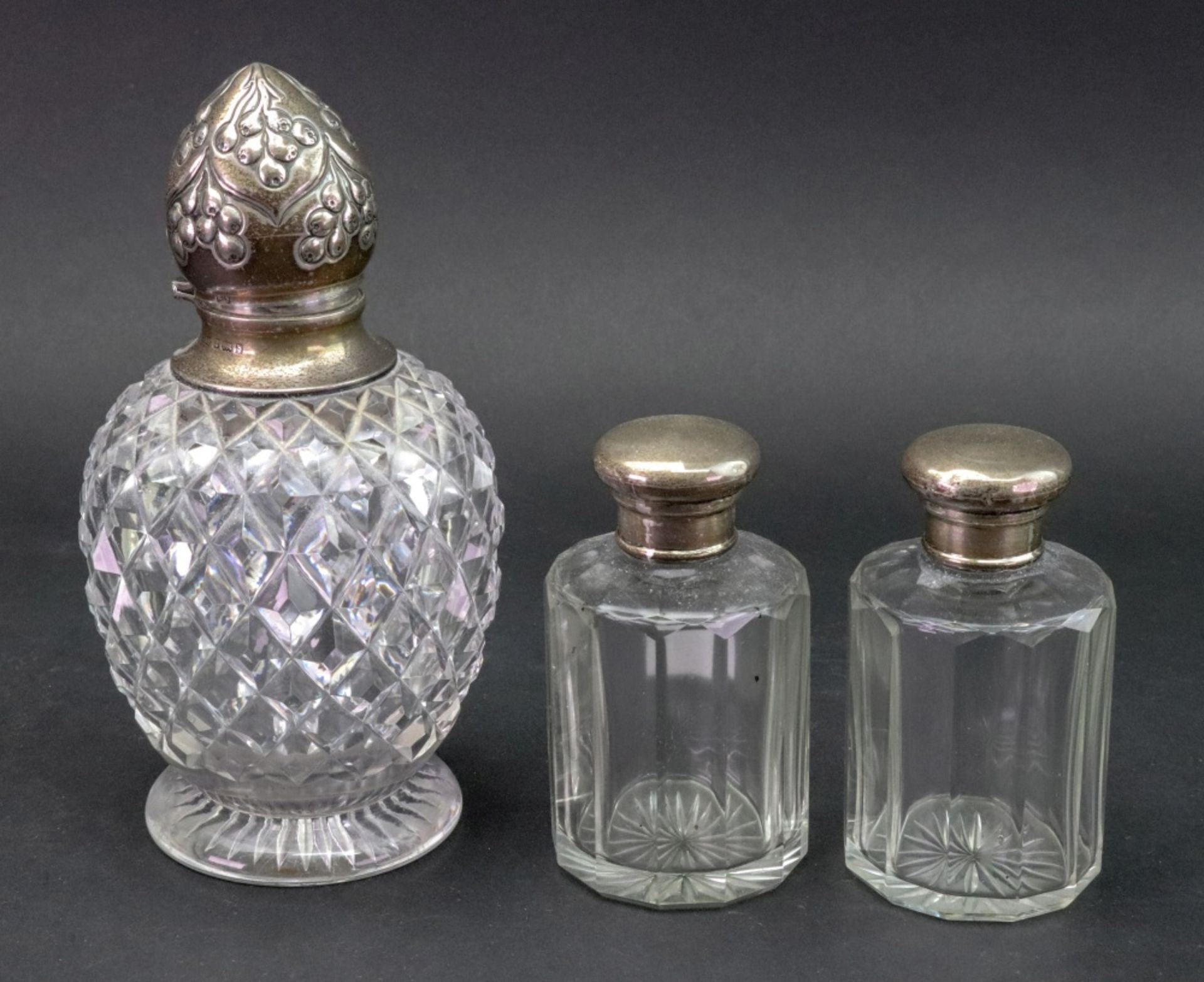 An Edwardian silver mounted diamond cut glass baluster shape perfume bottle, John Grinsell & Sons,