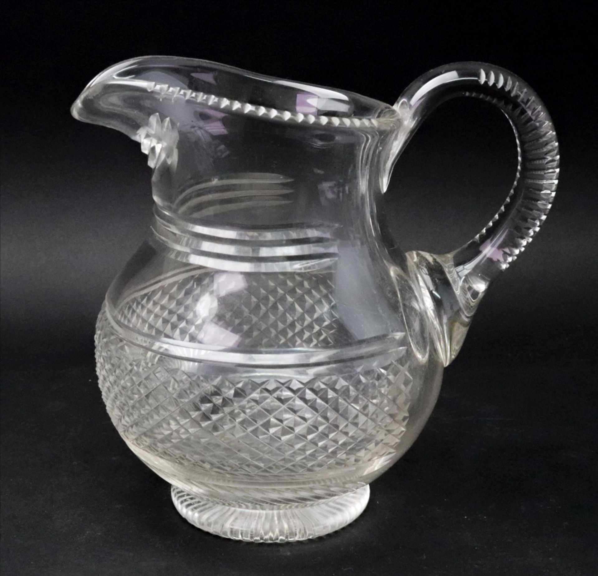 A Regency style glass baluster shape water jug, the wide diamond cut band with split cutting above,