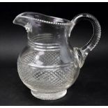 A Regency style glass baluster shape water jug, the wide diamond cut band with split cutting above,