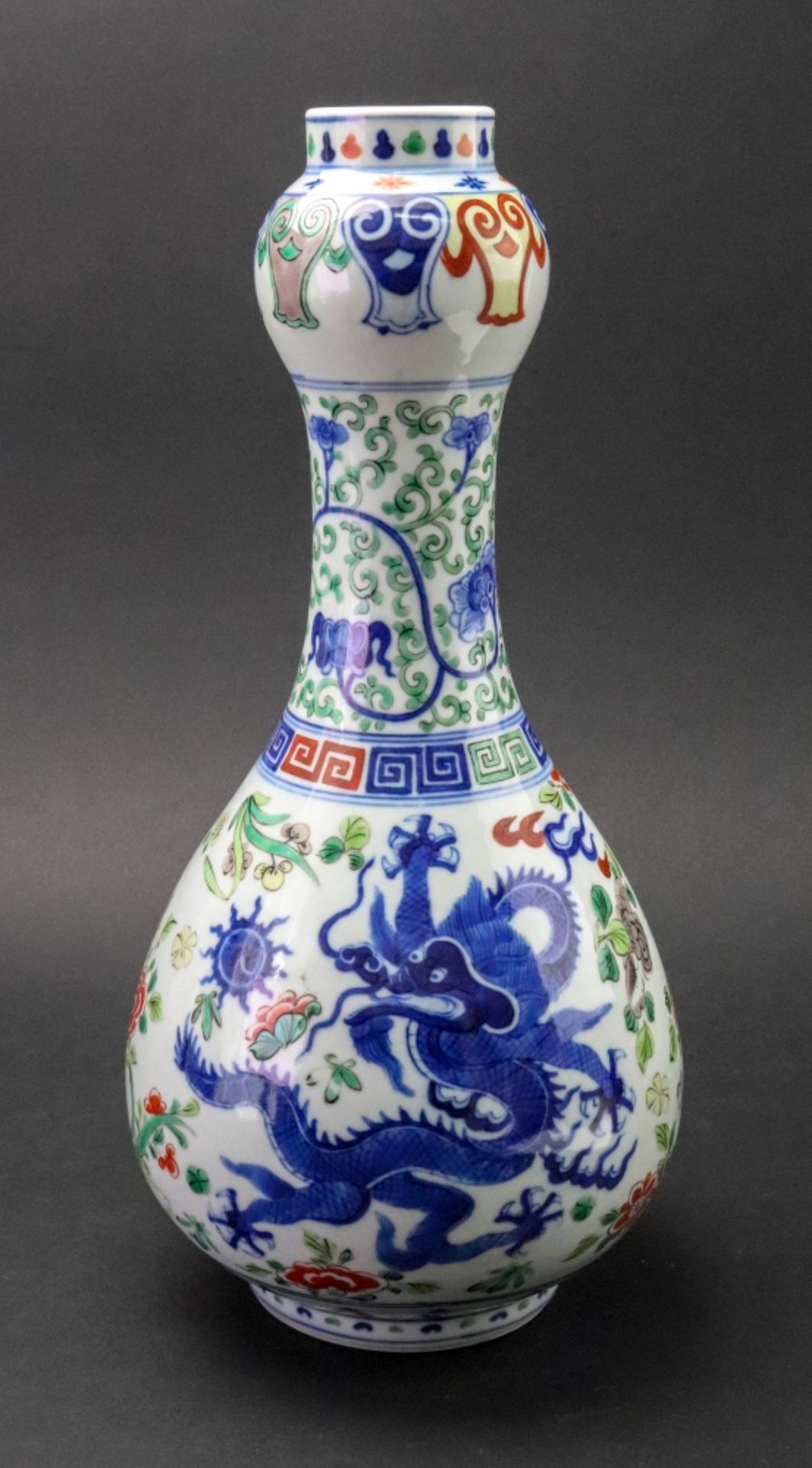 An elaborate Wucai garlic vase, in Wanli period style, with a tall ovoid body,