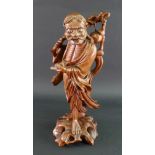 A Chinese carved wood figure of a man carrying a branch over his shoulder, 20th century, 38cm high.
