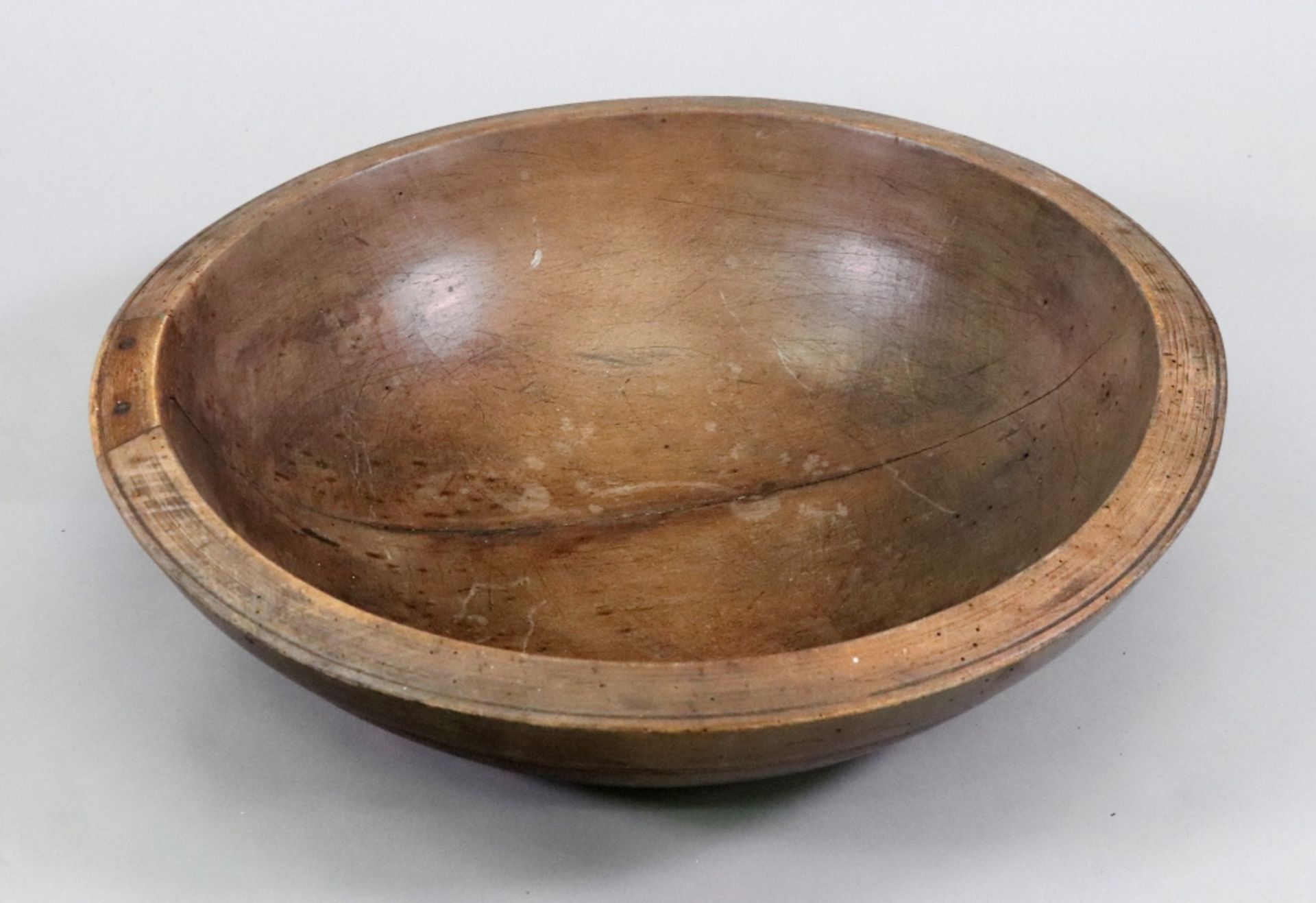 A turned fruitwood dairy bowl, 19th century, 50cm diameter x 15cm high.