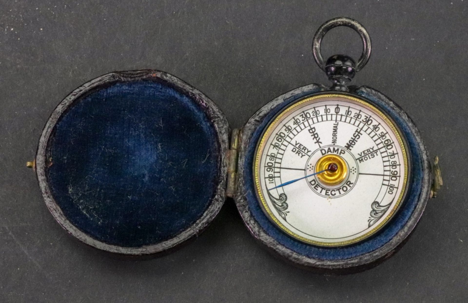 A damp detector in japanned metal case, 3.5cm diameter, in Victorian leather covered carrying case.