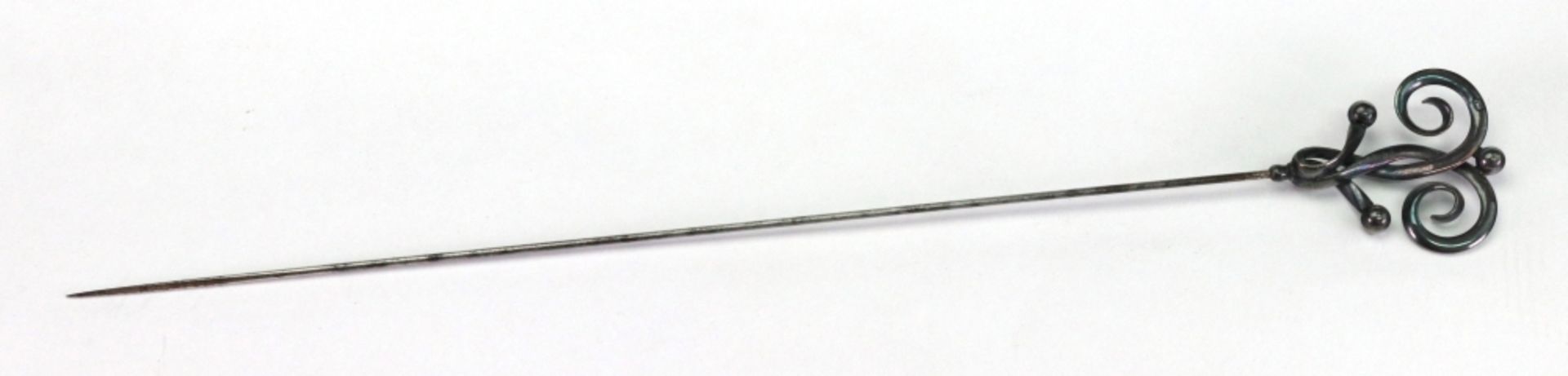 A Charles Horner silver mounted steel hat pin, Chester 1913, of scrolled and bead design, 24cm long.