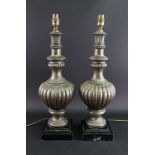 A pair of reproduction table lamps, of lobed and fluted baluster vase form, in 17th century style,