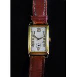 An 18ct gold wristwatch, the rectangular dial with Arabic numerals and subsidiary seconds dial,