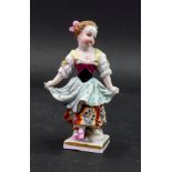 A Sampson porcelain figure of a young girl, her hands gathering up her dress, 11cm high.
