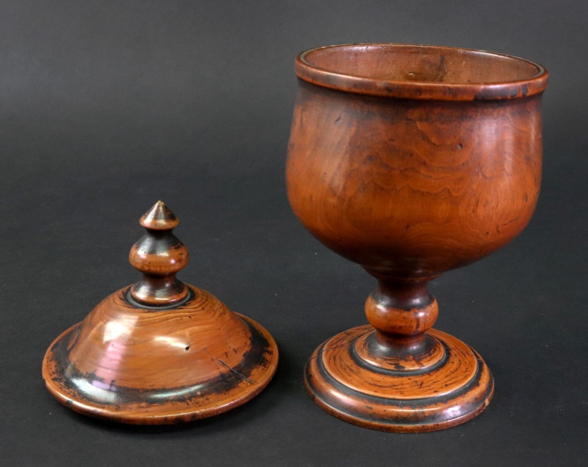 A turned fruitwood cup and cover, 18th century, the domed pull off cover with a turned finial, - Image 2 of 2