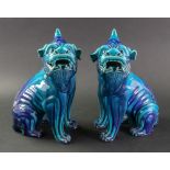 A pair of Chinese turquoise glazed foo dogs, in Ming style, 29cm high.