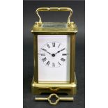 A French brass carriage timepiece, 20th century, the white enamel dial with Roman numerals,
