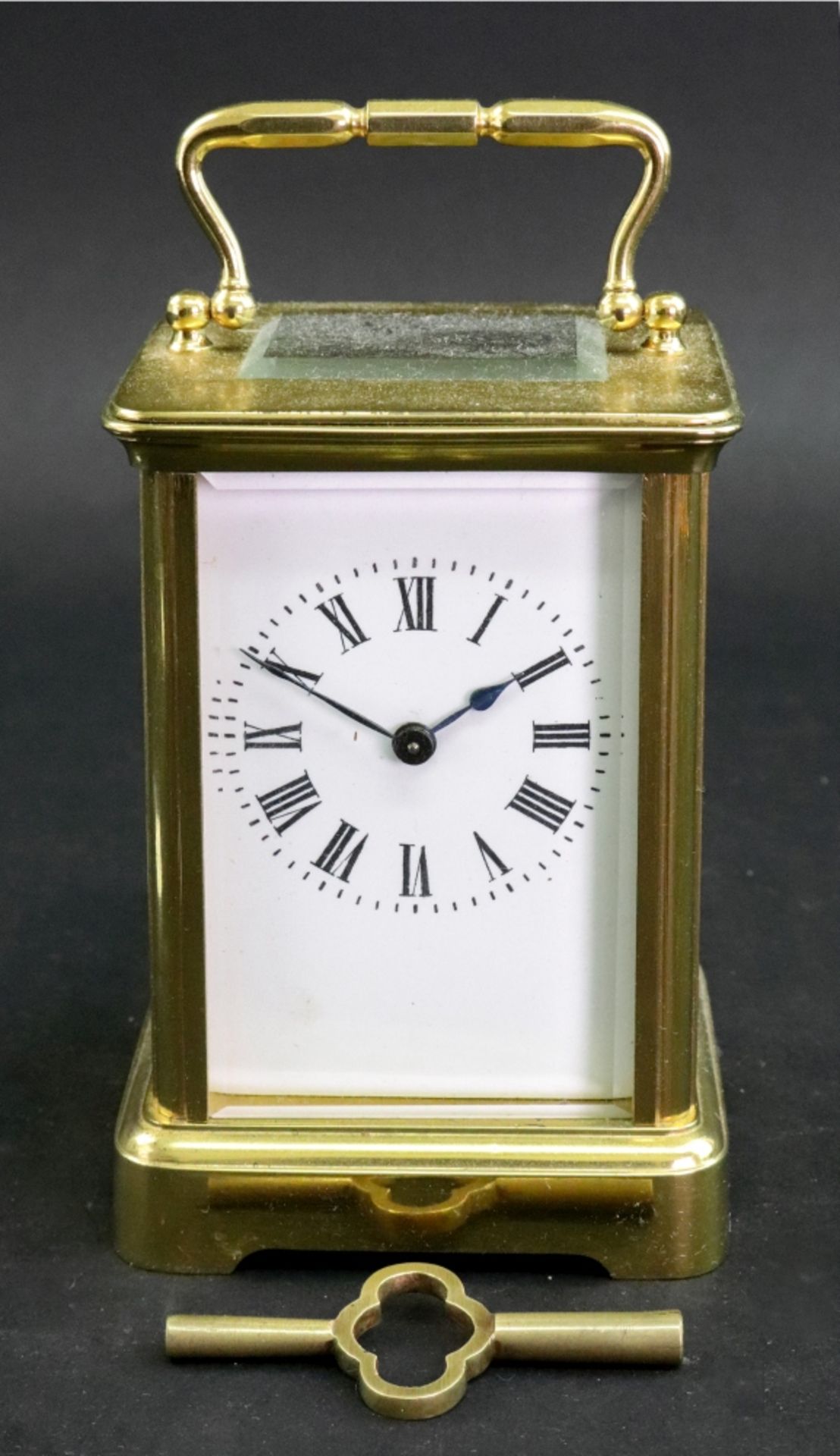 A French brass carriage timepiece, 20th century, the white enamel dial with Roman numerals,