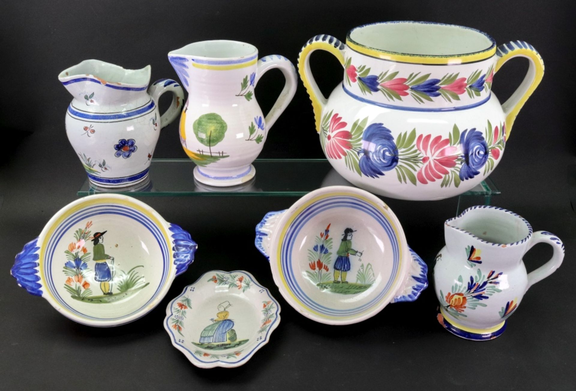 A group of Quimper Faience, 20th century, each piece painted with figures of flowers,