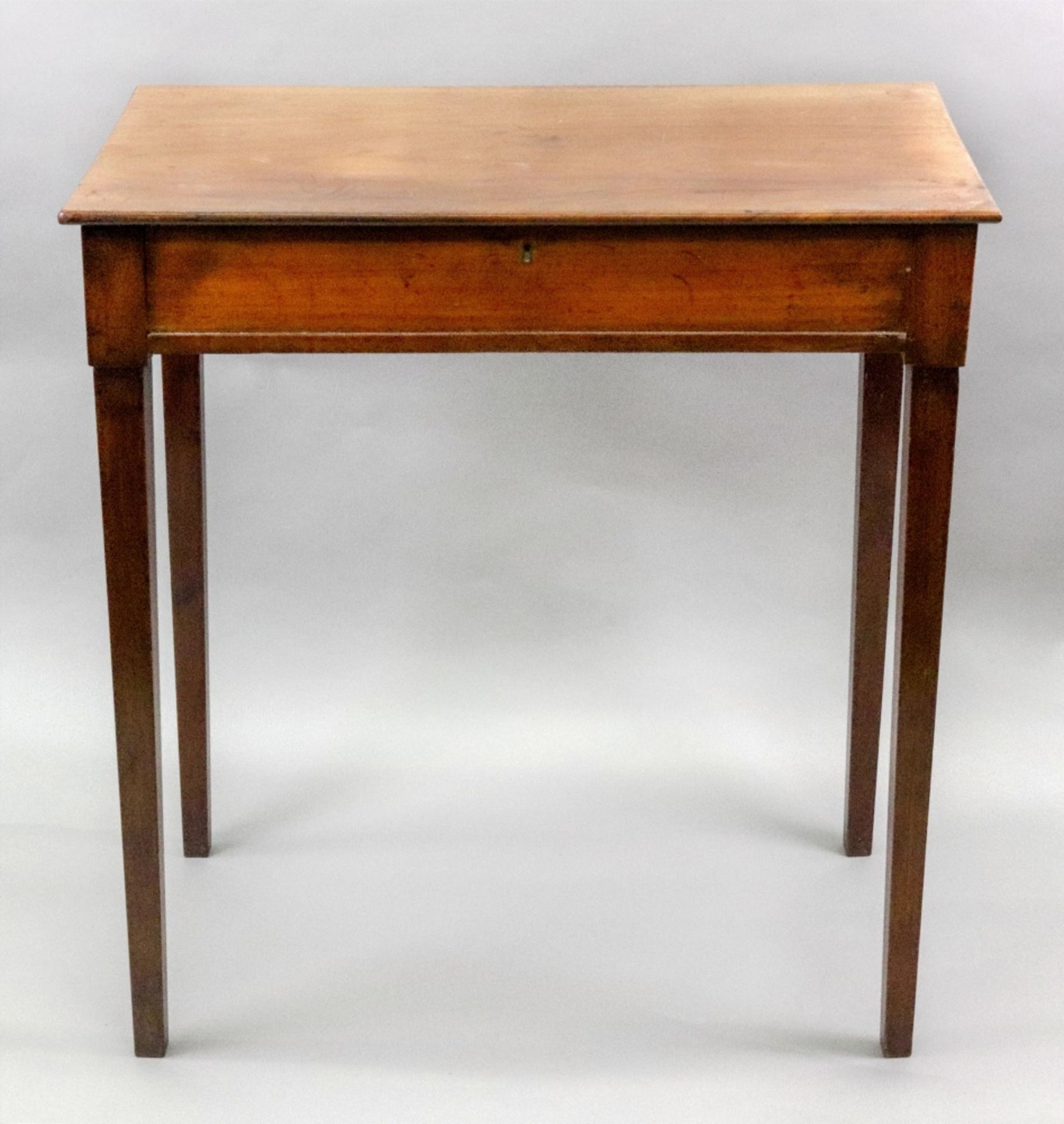 An early 19th century mahogany side table, the rectangular top above a frieze drawer,