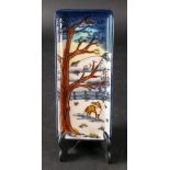 A boxed Moorcroft rectangular dish painted with a fox in a winter landscape, 20 x 8.5cm.