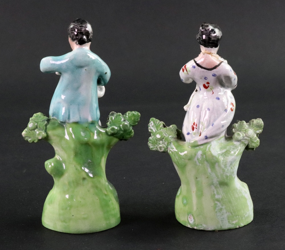 A pair of English pearlware figures modelled as a boy and girl, circa 1820, - Image 2 of 2