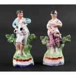 A pair of English pearlware figures modelled as a boy and girl, circa 1820,