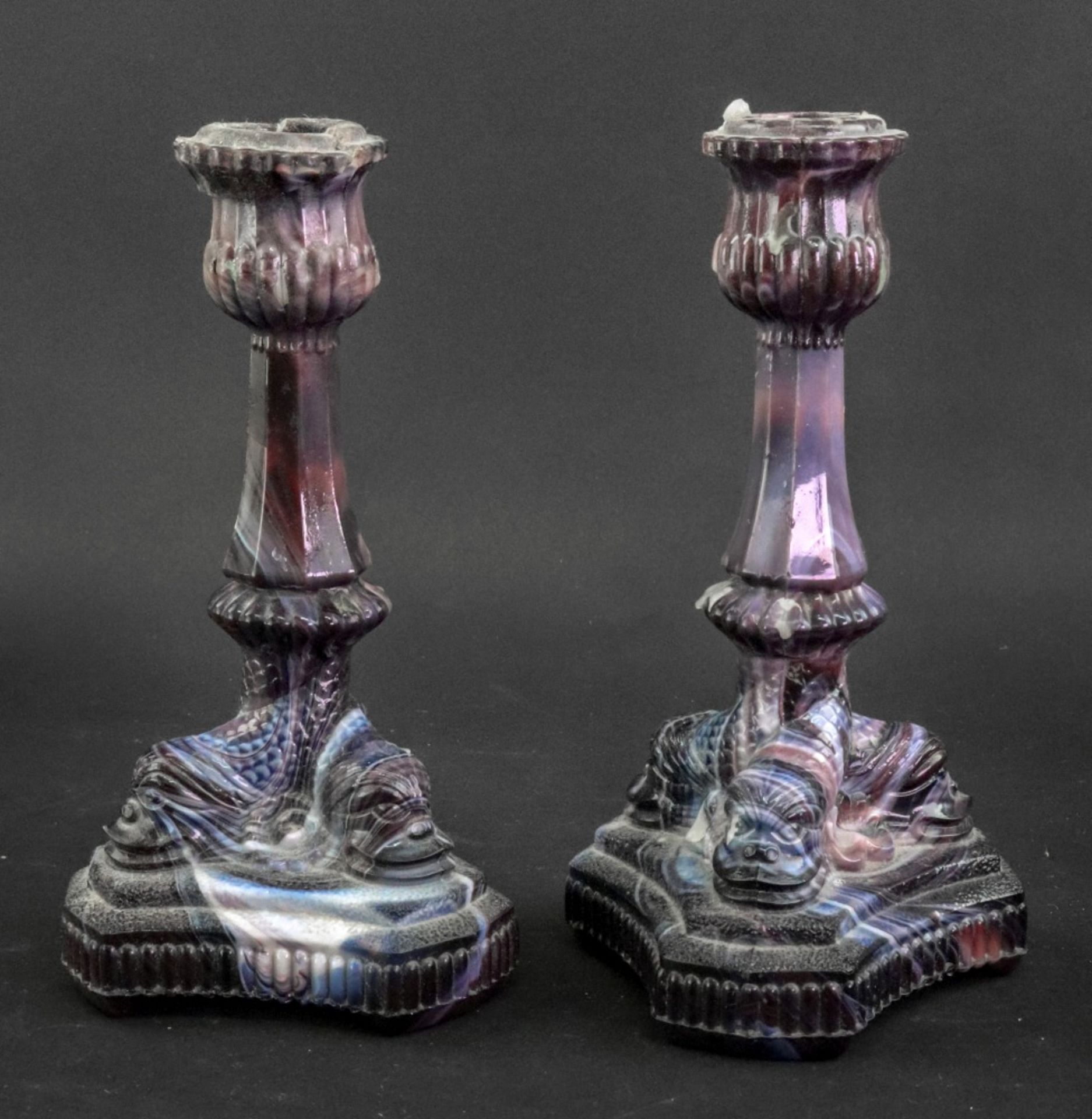 A pair of pressed glass candlesticks, late 19th century, of purple blue and white tones,