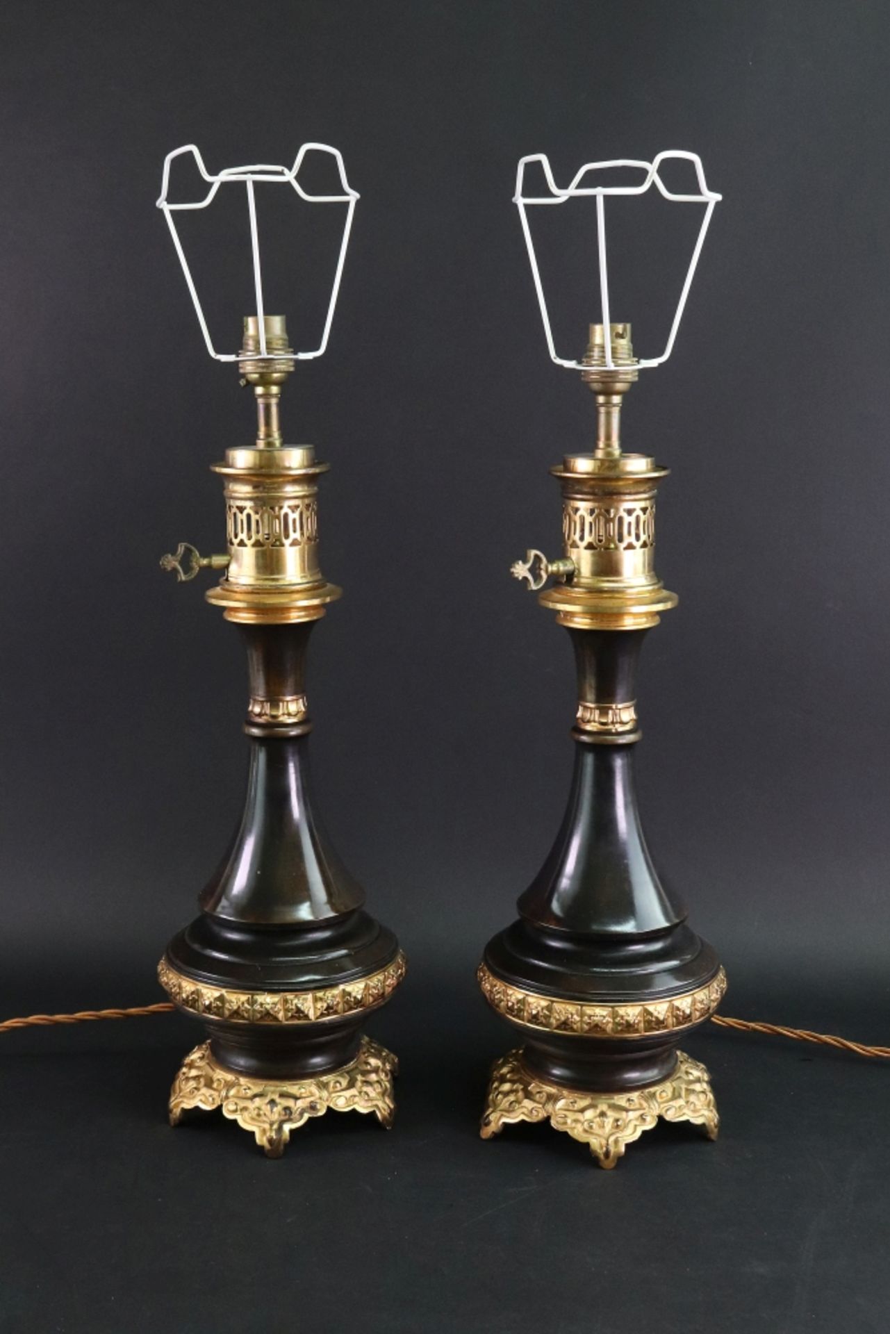 A pair of gilt metal and bronzed oil lamps adapted as table lamps, of vase form,