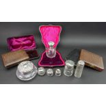 A collection of seven silver mounted glass dressing table and toilet jars, varying dates,