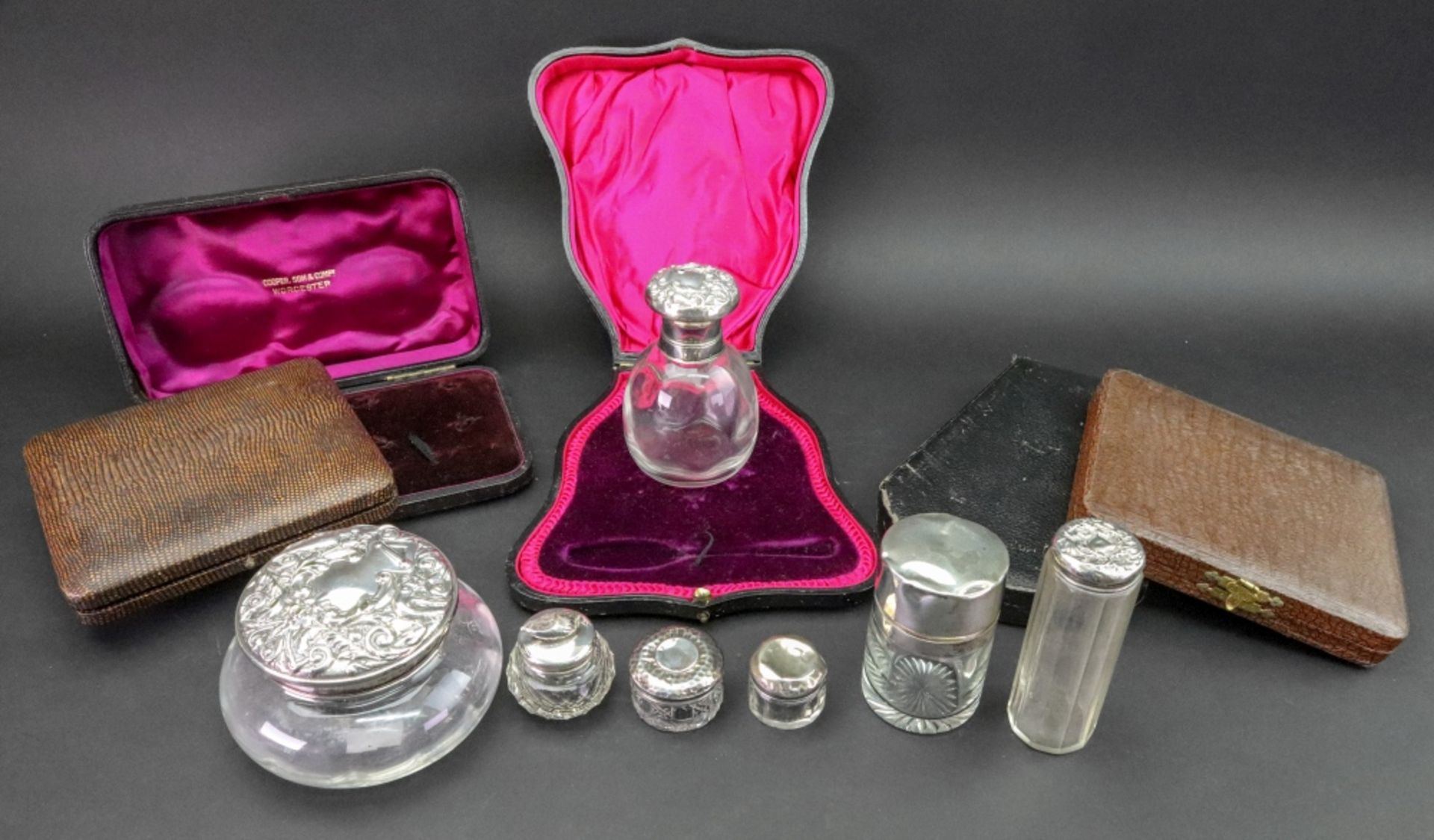 A collection of seven silver mounted glass dressing table and toilet jars, varying dates,