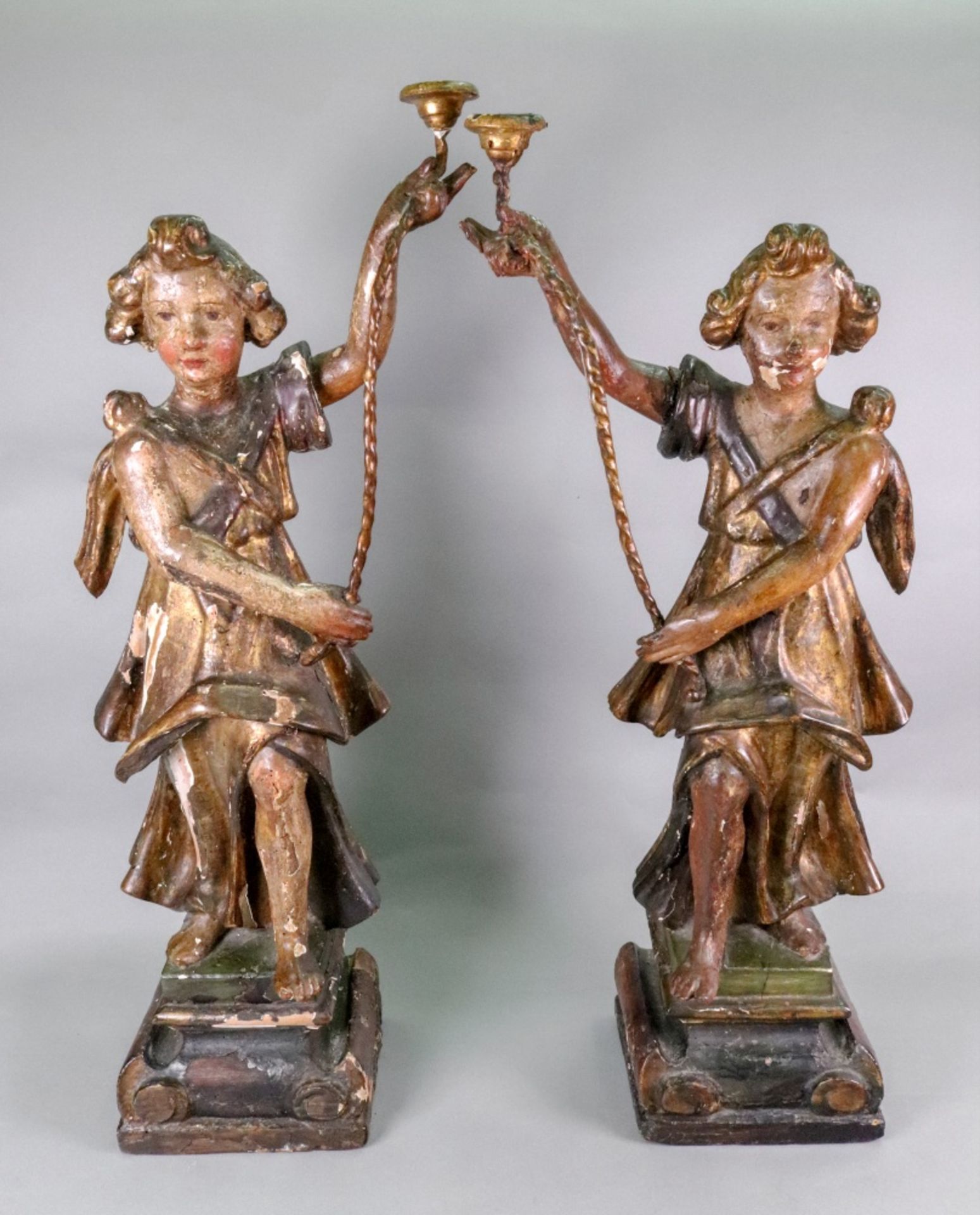 A pair of Italian carved pine polychrome painted gesso and parcel gilt candlesticks, 17th century,