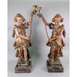 A pair of Italian carved pine polychrome painted gesso and parcel gilt candlesticks, 17th century,