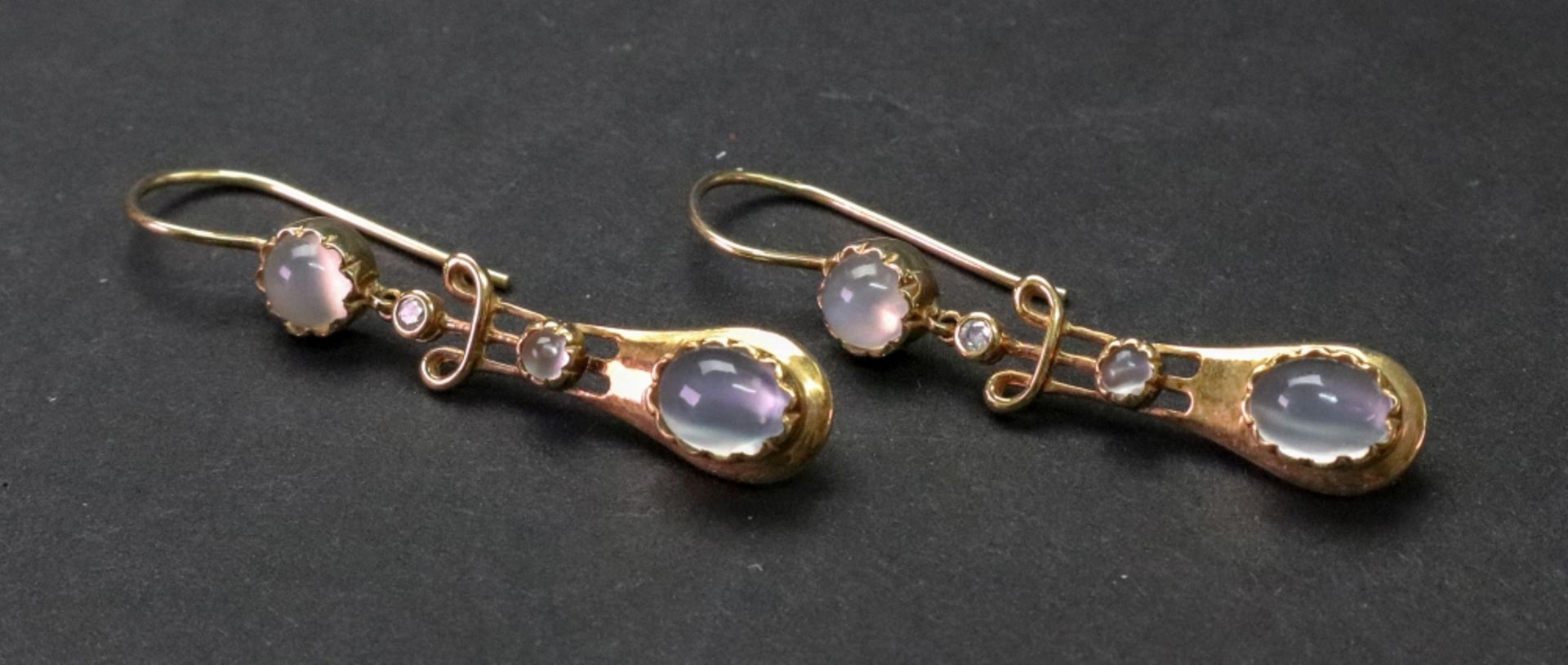 A pair of moonstone and diamond set pendant earrings in the antique style,