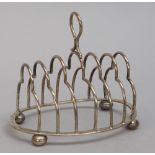 A late Victorian silver seven bar toastrack, of curved form with a loop handle,