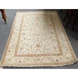 A Kashan rug, Persian, the ivory field with swirling design of leaf and floral sprays,