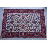 An Isfahan rug, Persian, the ivory field with a central flowerhead,