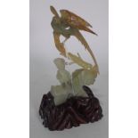 A Chinese bowenite group of two birds, 20th century, of celadon and russet tone, 19cm high,