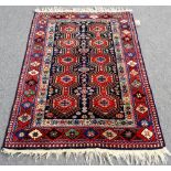 A South Persian rug, deep blue filed with parallel rows of pole medallions of hexagonal form,