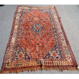 A Ghashgai carpet, South Persian, the floral madder field with a hooked central medallion,