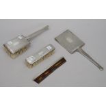 A lady's silver mounted four piece composite dressing set, comprising; a hand mirror, a hair brush,