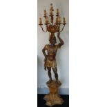 A pair of mid-20th century carved wooden figural candelabra,