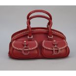 A Christian Dior red calf leather detective bag with two top handles and two exterior buckle front