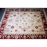 A modern Persian carpet, the ivory field with delicate madder, single palmettes,