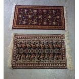 A Baluchistan rug, the black field with stylized flowerheads,