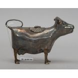 A silver cow creamer, modelled as a standing cow,
