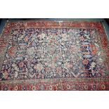 An Heriz carpet, Persian, the dark indigo field with a central madder diamond,