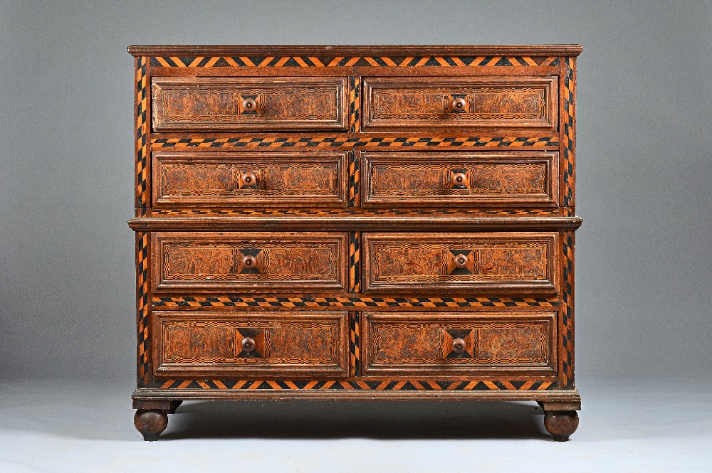 A late 17th century oak two part chest of eight short drawers,