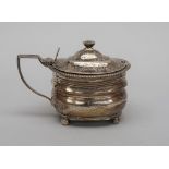 A George III mustard pot, of curved form, decorated with a reeded band,