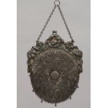 A lady's silver mounted purse, having a textile lining, the mount embossed with flowers,