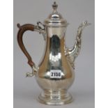 An early George III silver coffee pot, of baluster form, decorated with gadrooned rims,