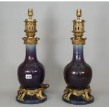 A pair of aubergine glaze porcelain table lamps,