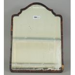 A late Victorian tortoiseshell strut back table mirror, with shaped top over a rectangular frame,
