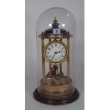 A Torsion anniversary clock, within a glass dome case, 45cm high.