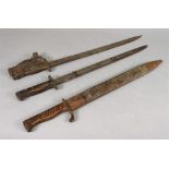 A collection of three bayonets, one in leather scabbard.