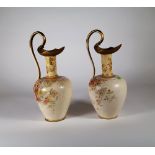 Royal Doulton Burslem; a pair of vases formed as ewers decorated with flowers, 35cm high, (2).