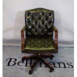 A 20th century Gainsborough style office open armchair with faux green leather button back